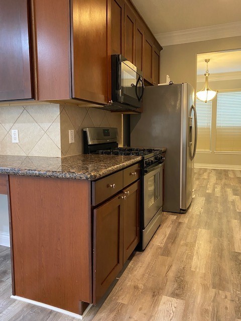 3415 Clearview Circle Houston, TX 77025 - Photo 9 of 16 a kitchen with stainless steel appliances granite countertop a refrigerator a stove and a sink