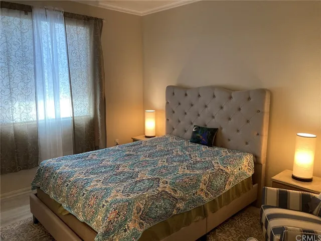 a bedroom with a bed and a lamp with window