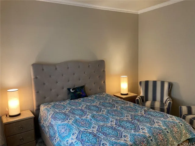 a bedroom with a bed and a lamp