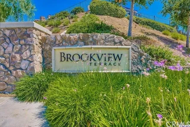 a front view of house with yard and swimming pool