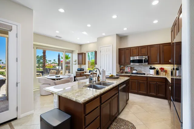 a view of a patio with swimming pool and sitting area