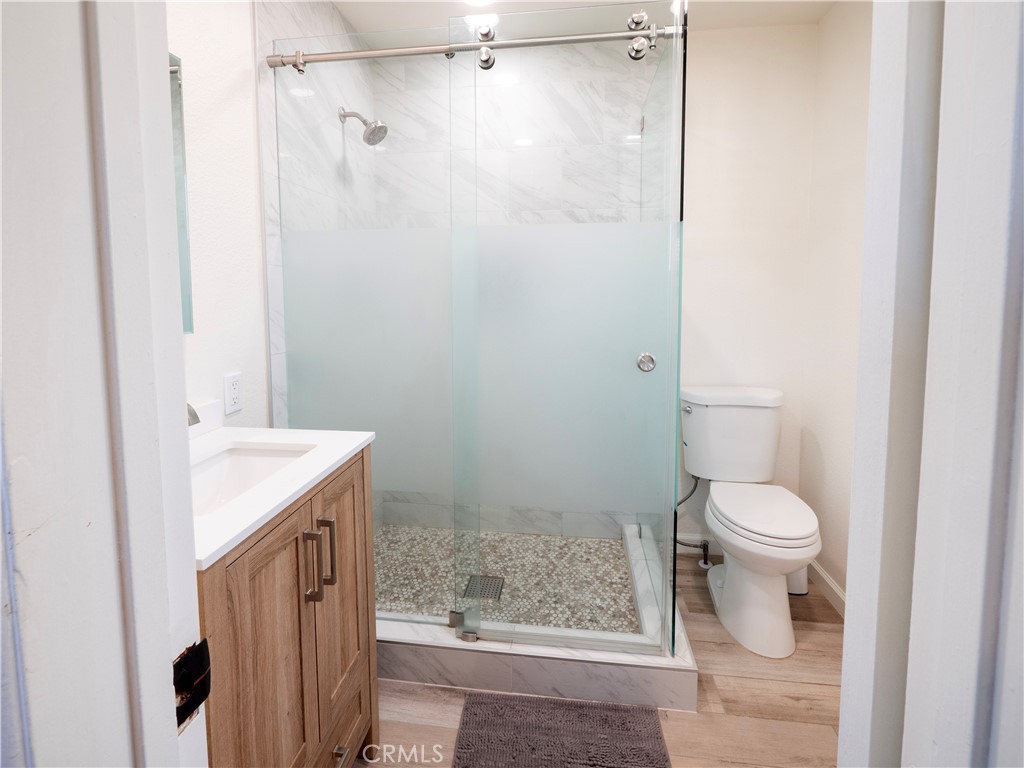 11665 Valverda Avenue Riverside, CA 92505 - Photo 14 of 52 a bathroom with a sink a toilet and shower