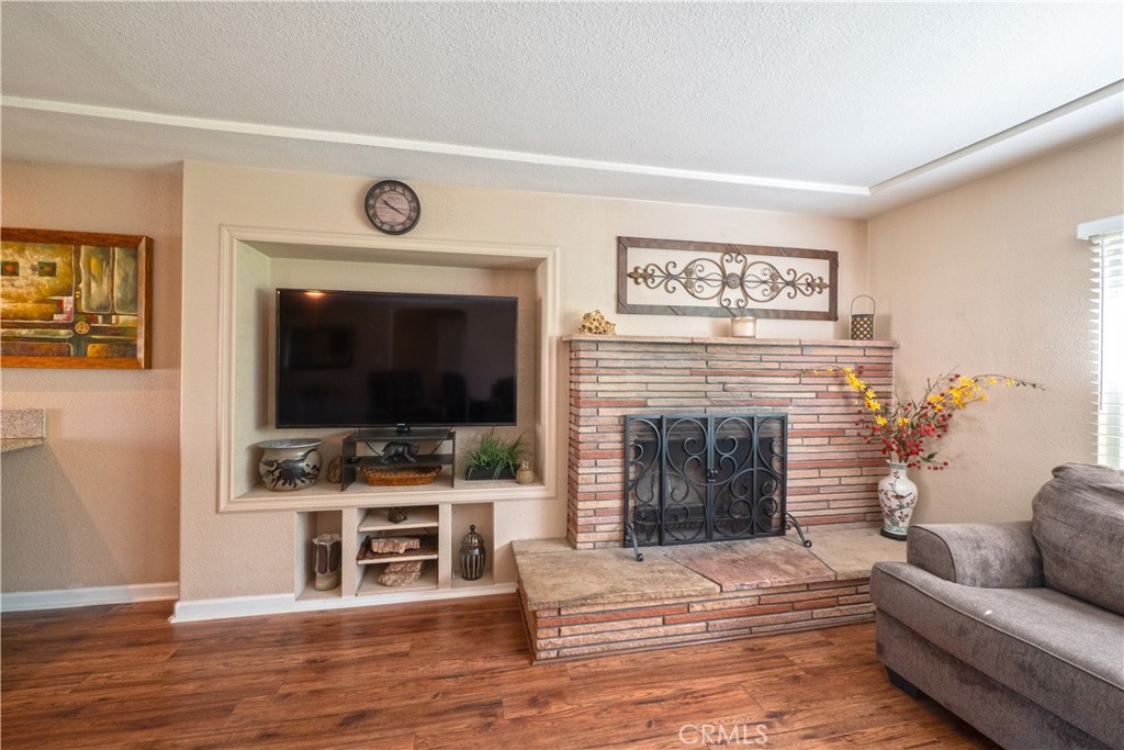 11665 Valverda Avenue Riverside, CA 92505 - Photo 15 of 53 a living room with furniture a flat screen tv and a fireplace