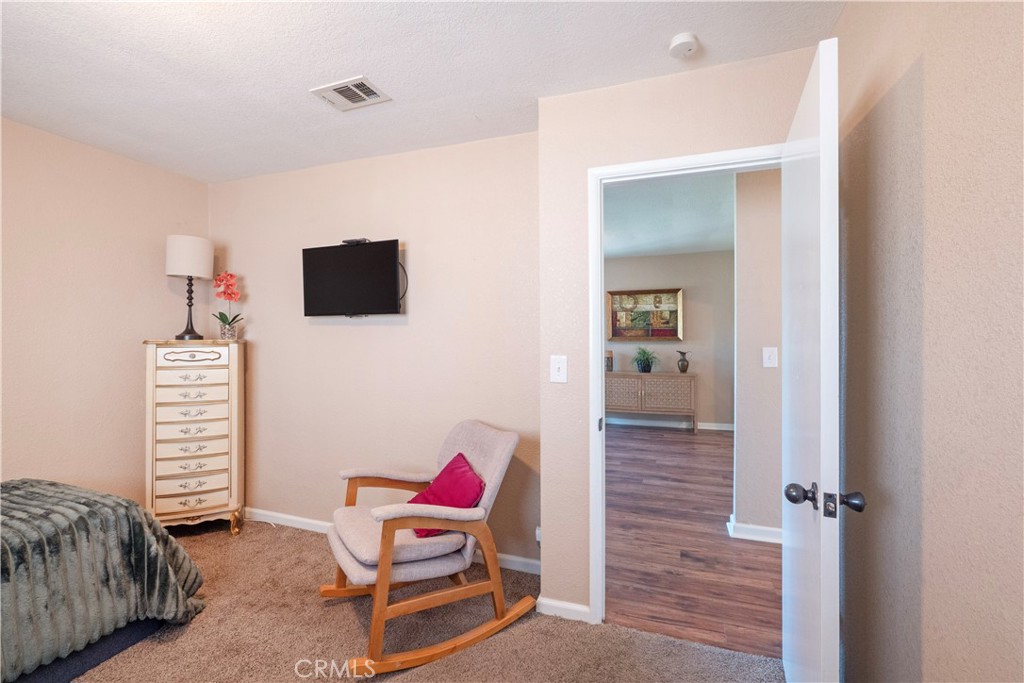 11665 Valverda Avenue Riverside, CA 92505 - Photo 19 of 52 a living room with furniture and a flat screen tv
