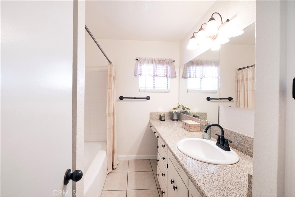11665 Valverda Avenue Riverside, CA 92505 - Photo 20 of 52 a bathroom with a sink a toilet a mirror and shower