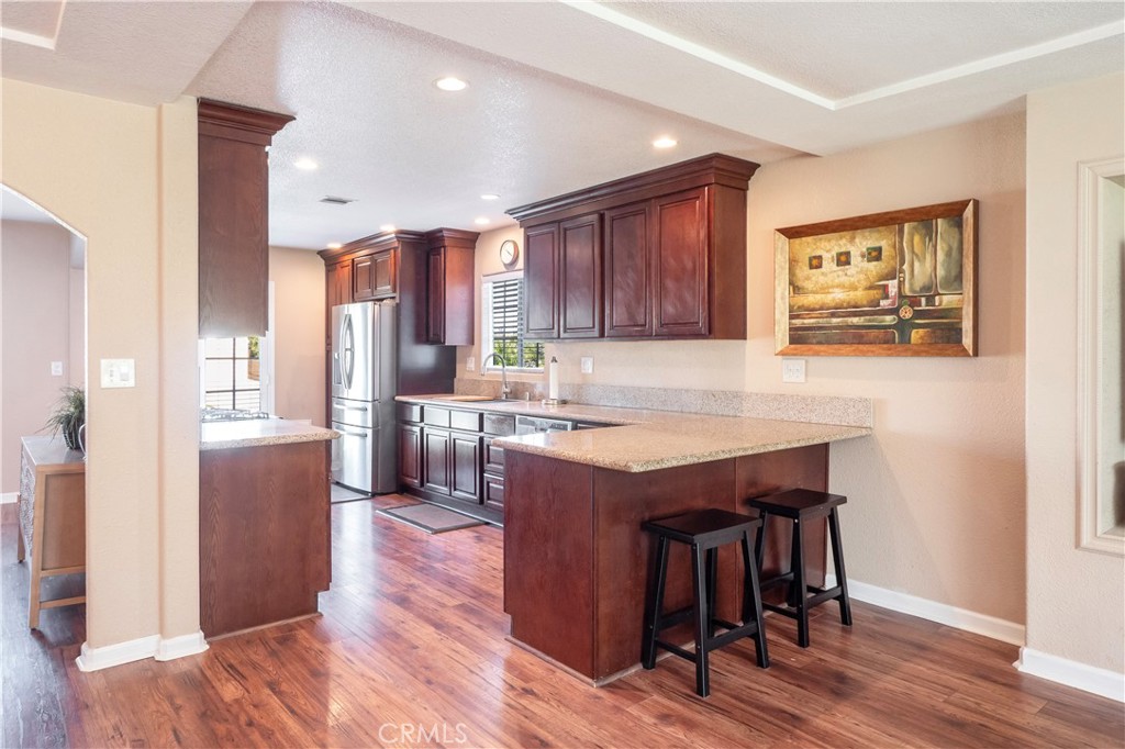 11665 Valverda Avenue Riverside, CA 92505 - Photo 2 of 53 a living room with stainless steel appliances granite countertop furniture wooden floor and a view of kitchen
