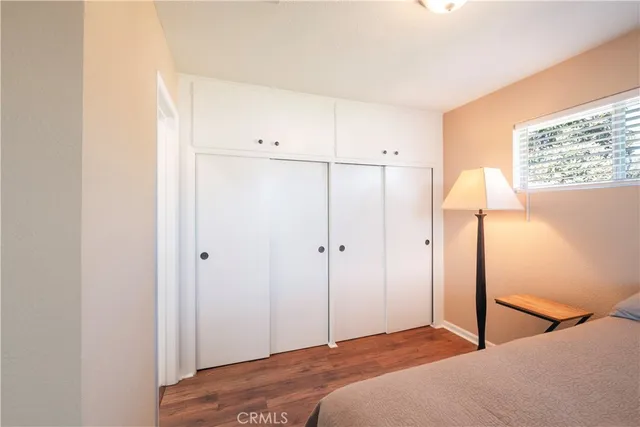 a bedroom with a bed and a lamp