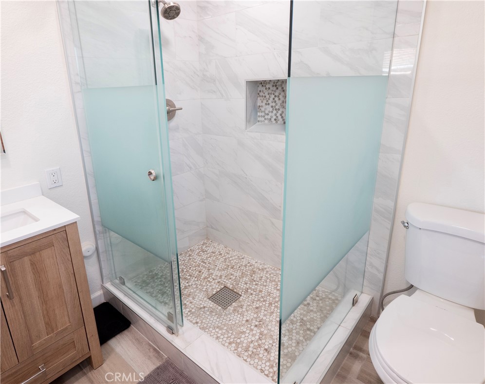 11665 Valverda Avenue Riverside, CA 92505 - Photo 25 of 53 a bathroom with a shower and toilet