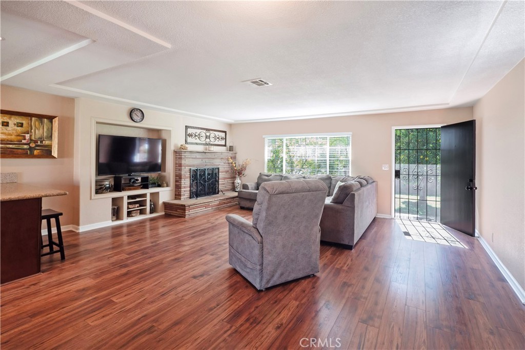 11665 Valverda Avenue Riverside, CA 92505 - Photo 4 of 53 a living room with furniture and a flat screen tv