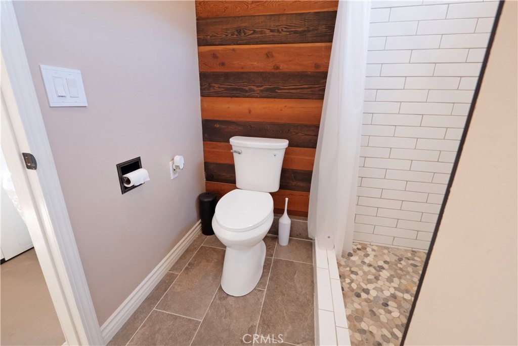 11665 Valverda Avenue Riverside, CA 92505 - Photo 43 of 53 a white toilet sitting next to a shower