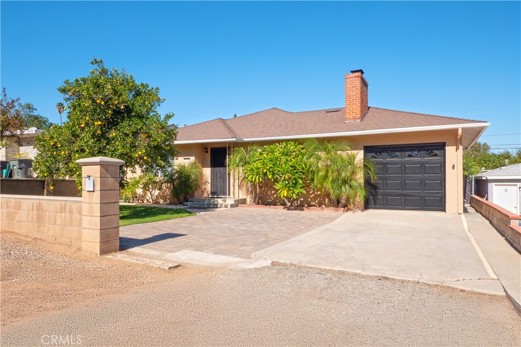 11665 Valverda Avenue Riverside, CA 92505 - Photo 47 of 52 a front view of a house with a yard and garage