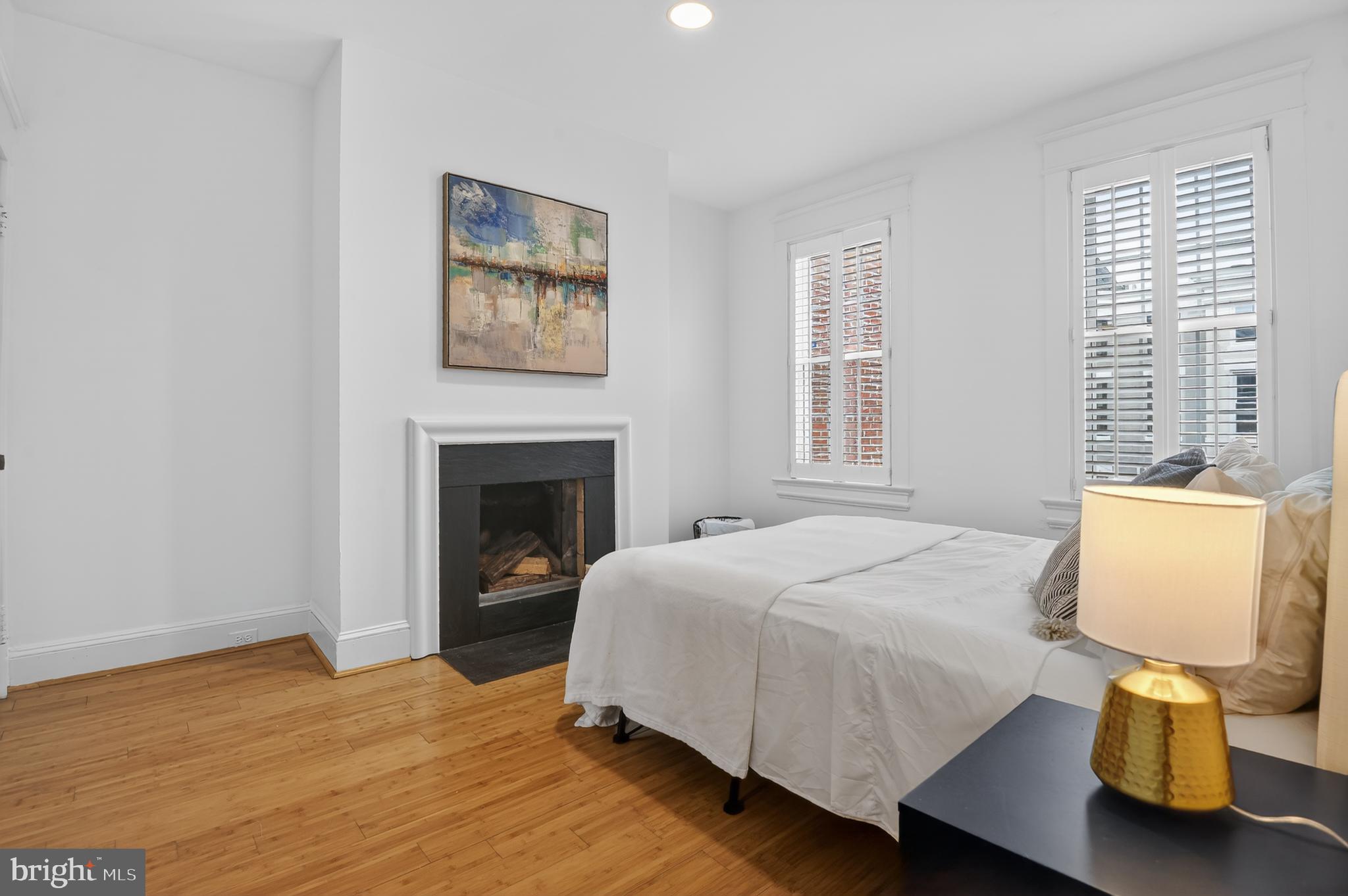 1752 Willard Street Northwest Washington, DC 20009 - Photo 17 of 26 a bedroom with a bed and wooden floor
