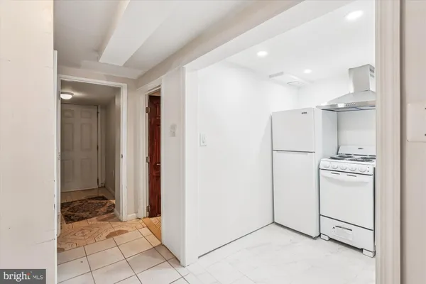 a view of a hallway with wooden floor and entryway
