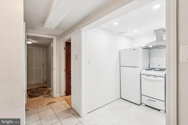 a view of a hallway with wooden floor and entryway