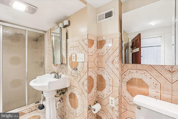 a bathroom with a bathtub sink and mirror