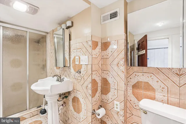 a bathroom with a bathtub sink and mirror