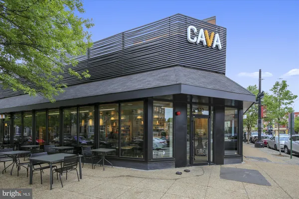 a street sign under a large building