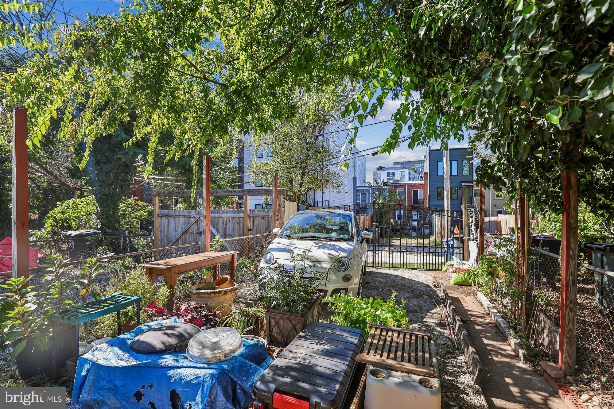 758 19th Street Northeast Washington, DC 20002 - Photo 5 of 23 a view of a patio with table and chairs potted plants and large tree