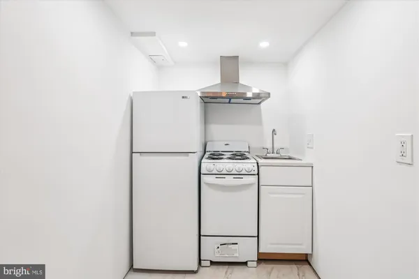 a view of a hallway with closet and utility room