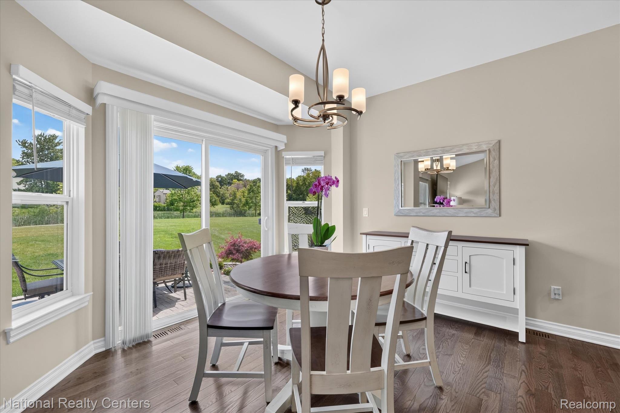 740 North Mill Street South Lyon, MI 48178 - Photo 16 of 56 Dining area featuring wood-finish flooring and a contemporary chandelier