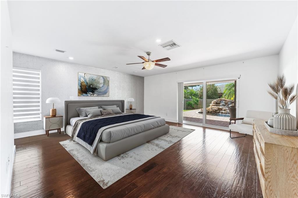2360 Outrigger Lane Naples, FL 34104 - Photo 20 of 50 a spacious bedroom with a bed and a large window