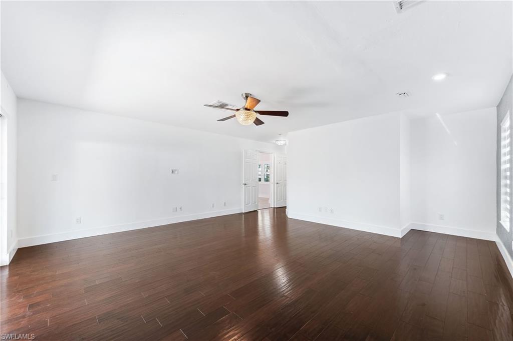 2360 Outrigger Lane Naples, FL 34104 - Photo 23 of 50 a view of a room with wooden floor and white walls