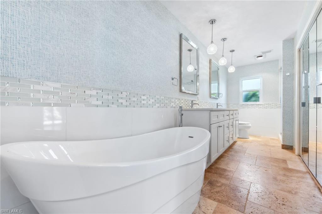 2360 Outrigger Lane Naples, FL 34104 - Photo 25 of 50 a spacious bathroom with a bathtub and a shower