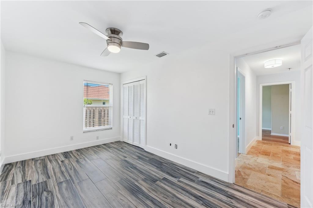 2360 Outrigger Lane Naples, FL 34104 - Photo 36 of 50 a view of an empty room with wooden floor and a window