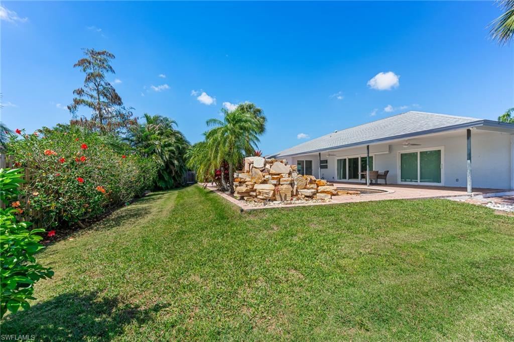 2360 Outrigger Lane Naples, FL 34104 - Photo 46 of 50 a swimming pool with outdoor seating and yard