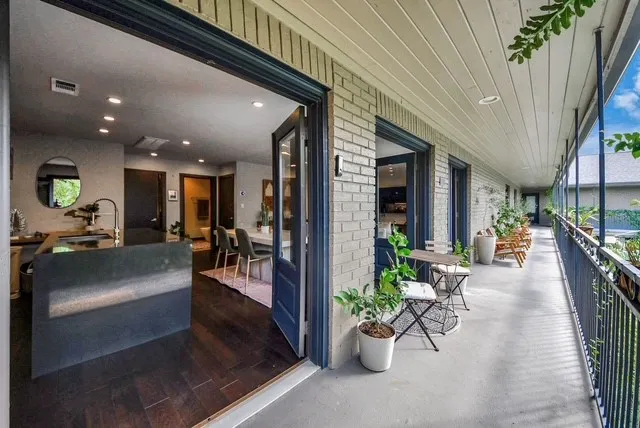 a lobby with furniture and potted plants