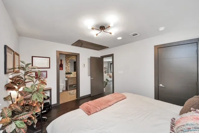 a bedroom with a bed and a chandelier