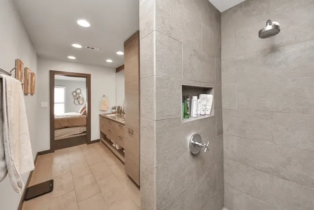 a bathroom with a double vanity sink a tub and shower