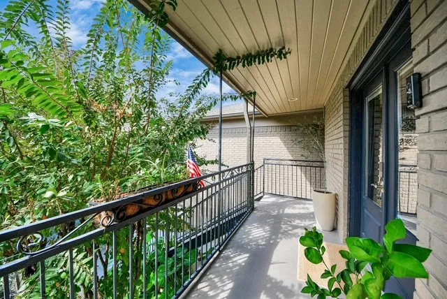 a view of a pathway of a balcony with a tree