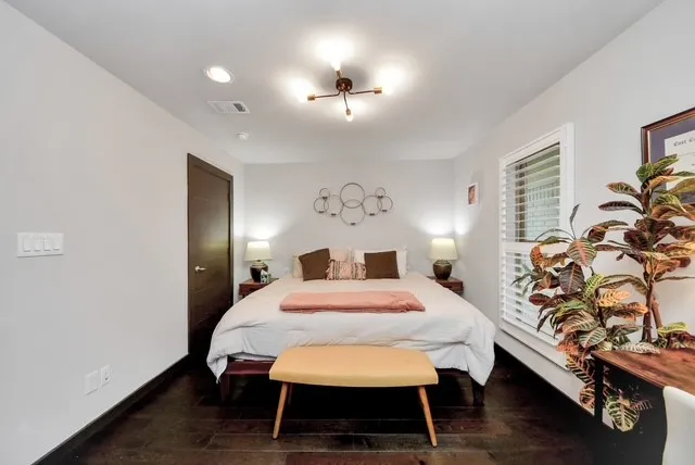 a bedroom with a bed and a chandelier