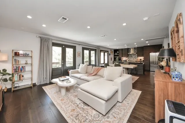 a living room with furniture and a wooden floor