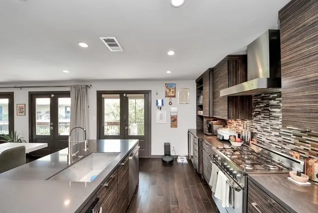 a kitchen with sink stove and cabinets