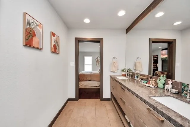 a bathroom with a double vanity sink and a mirror