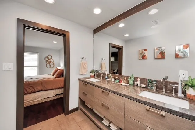 a en suite bathroom with sinks mirror and vanity