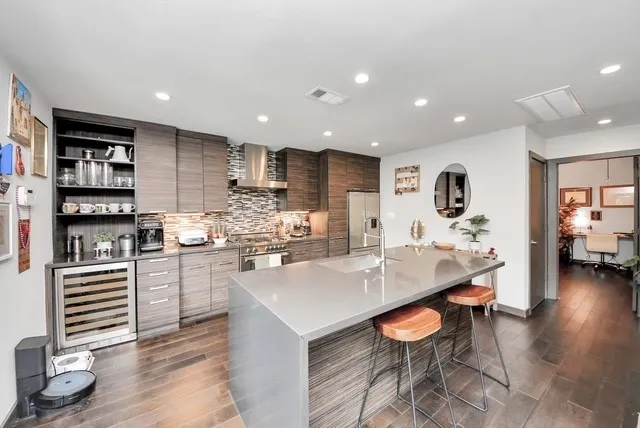 a kitchen with stainless steel appliances kitchen island granite countertop a sink and cabinets
