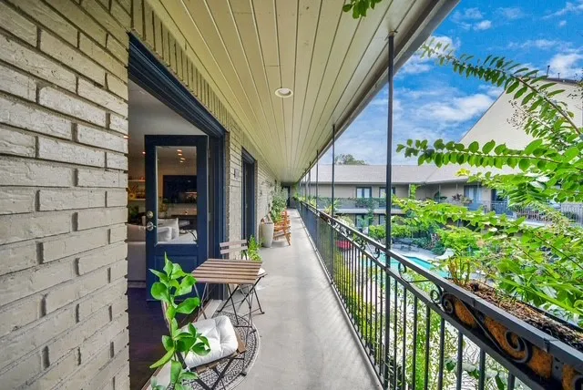 a view of a balcony with wooden floor and plants