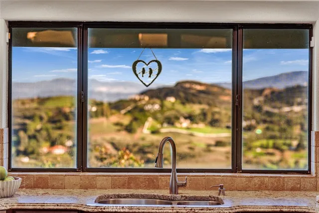 a view of empty room with a sink and cabinets