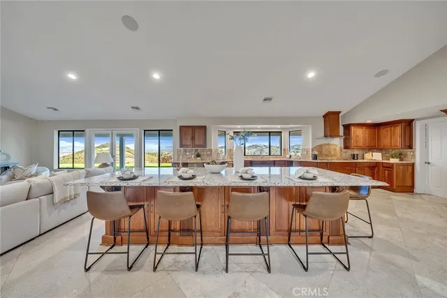 a kitchen with stainless steel appliances a sink and a large window