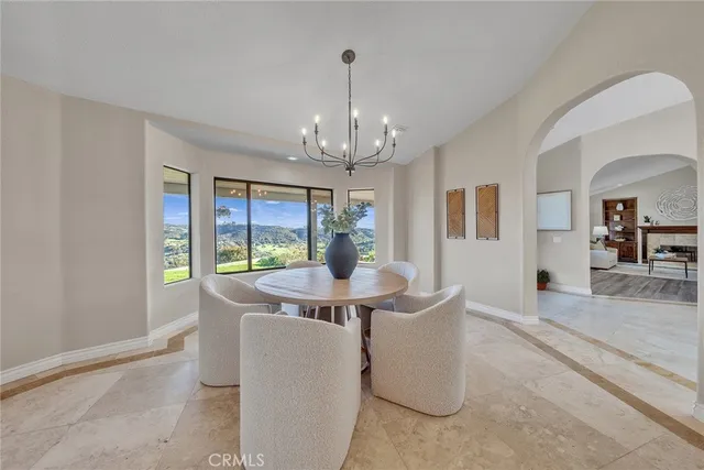 a spacious bedroom with a bed a dresser and wooden floor