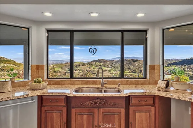 a view of a lush green field with a view of mountains