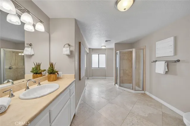 a spacious bedroom with a large bed and a large window