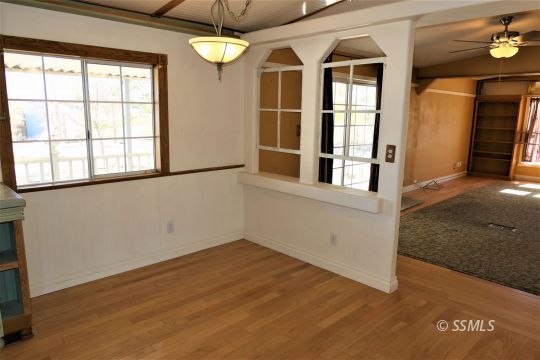 400 South Guam Street Ridgecrest, CA 93555 - Photo 22 of 39 an empty room with wooden floor and windows