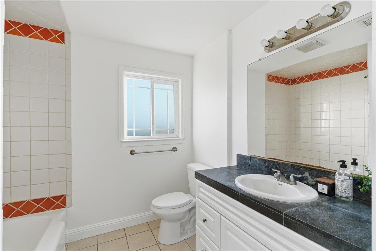 1610 Soto Street Seaside, CA 93955 - Photo 13 of 20 a bathroom with a granite countertop sink and a mirror