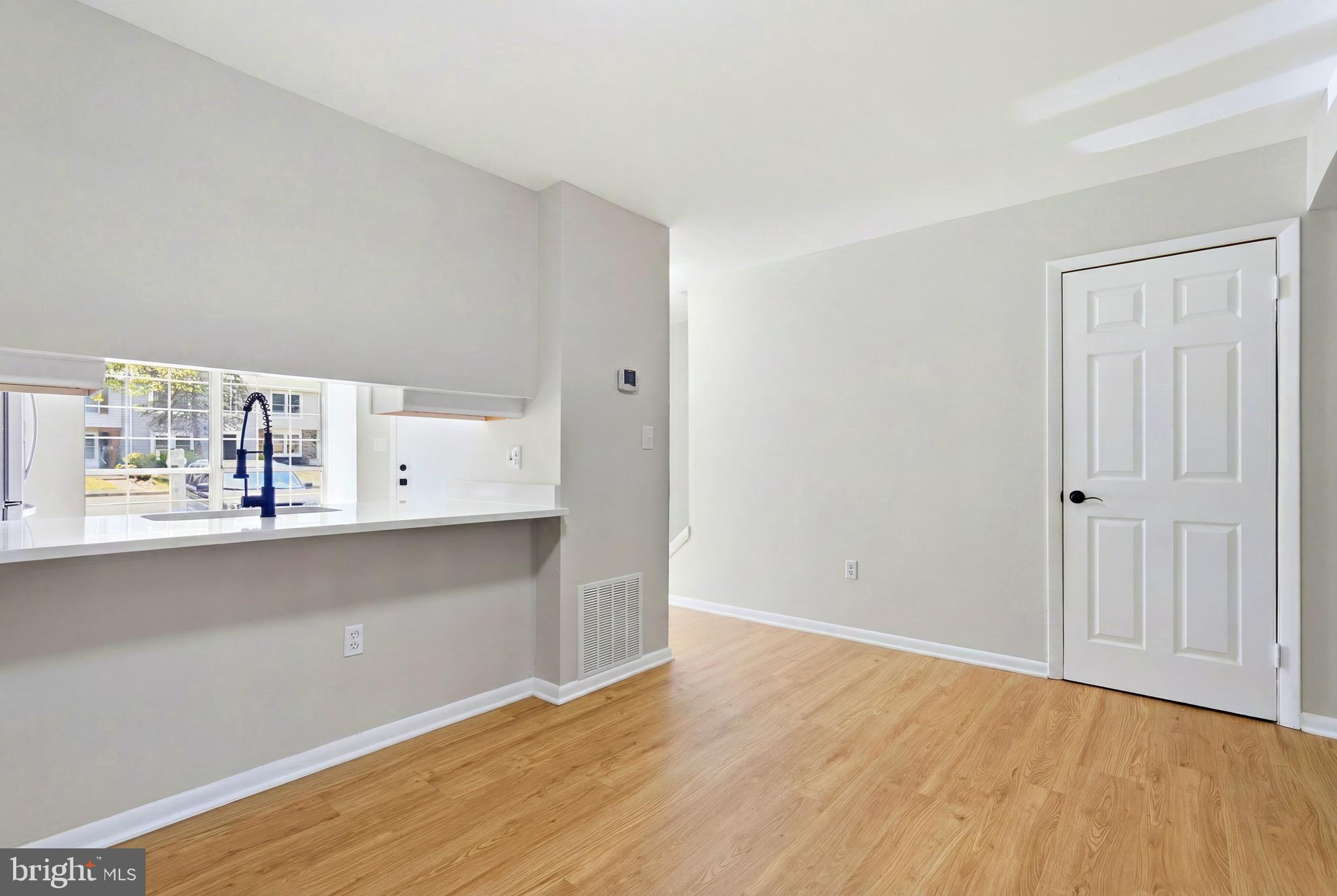 3682 Masthead Trail Triangle, VA 22172 - Photo 13 of 53 a view of an empty room with kitchen and a window