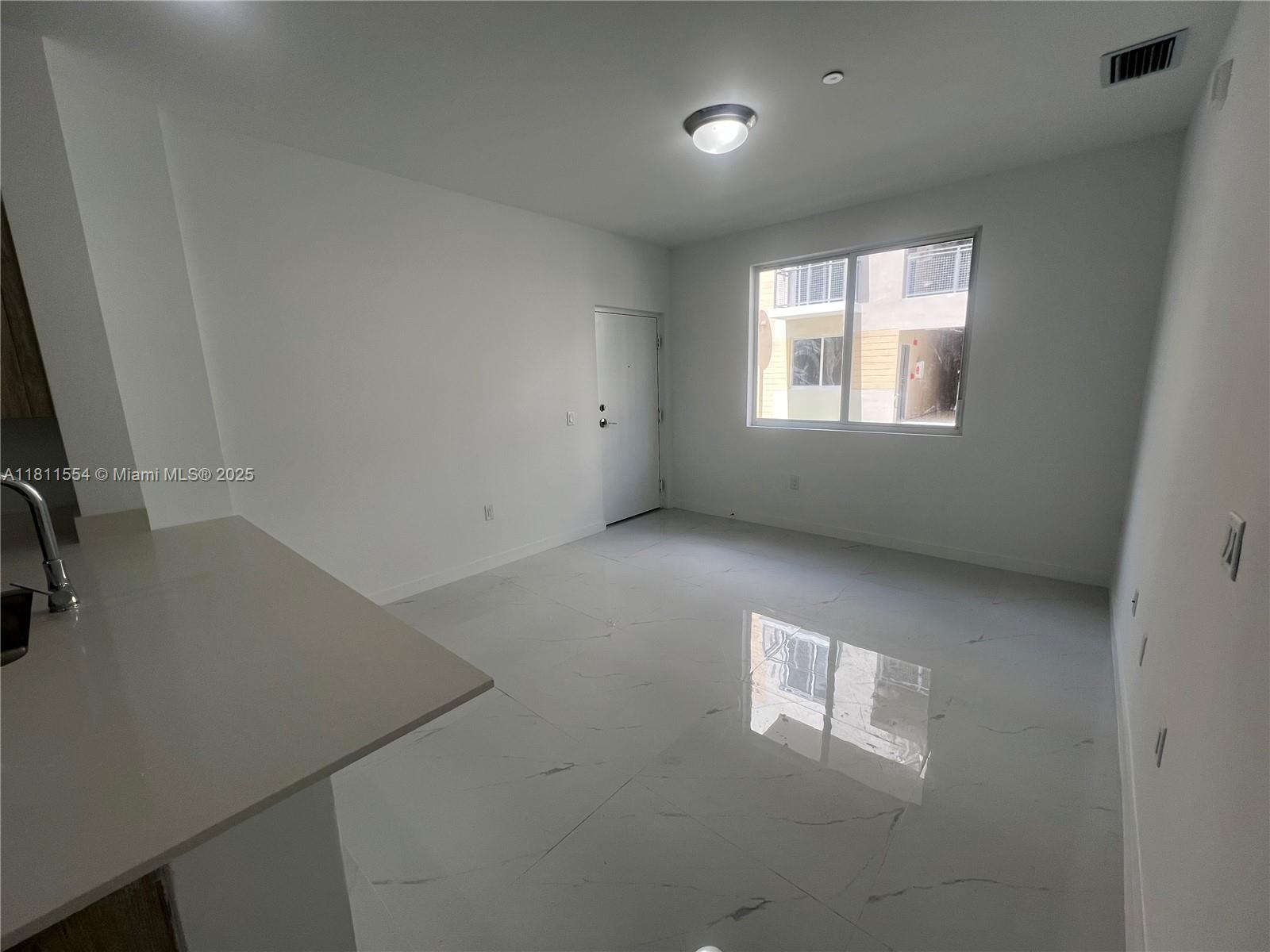 1010 Southwest 69th Avenue, Unit 212 Miami, FL 33144 - Photo 14 of 30 an empty room with a window