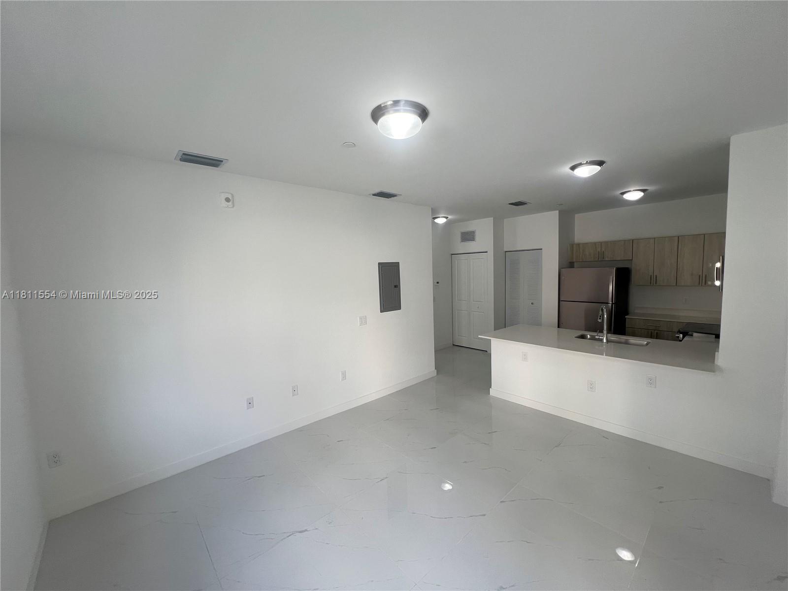 1010 Southwest 69th Avenue, Unit 212 Miami, FL 33144 - Photo 15 of 30 a view of a kitchen with a sink and a refrigerator